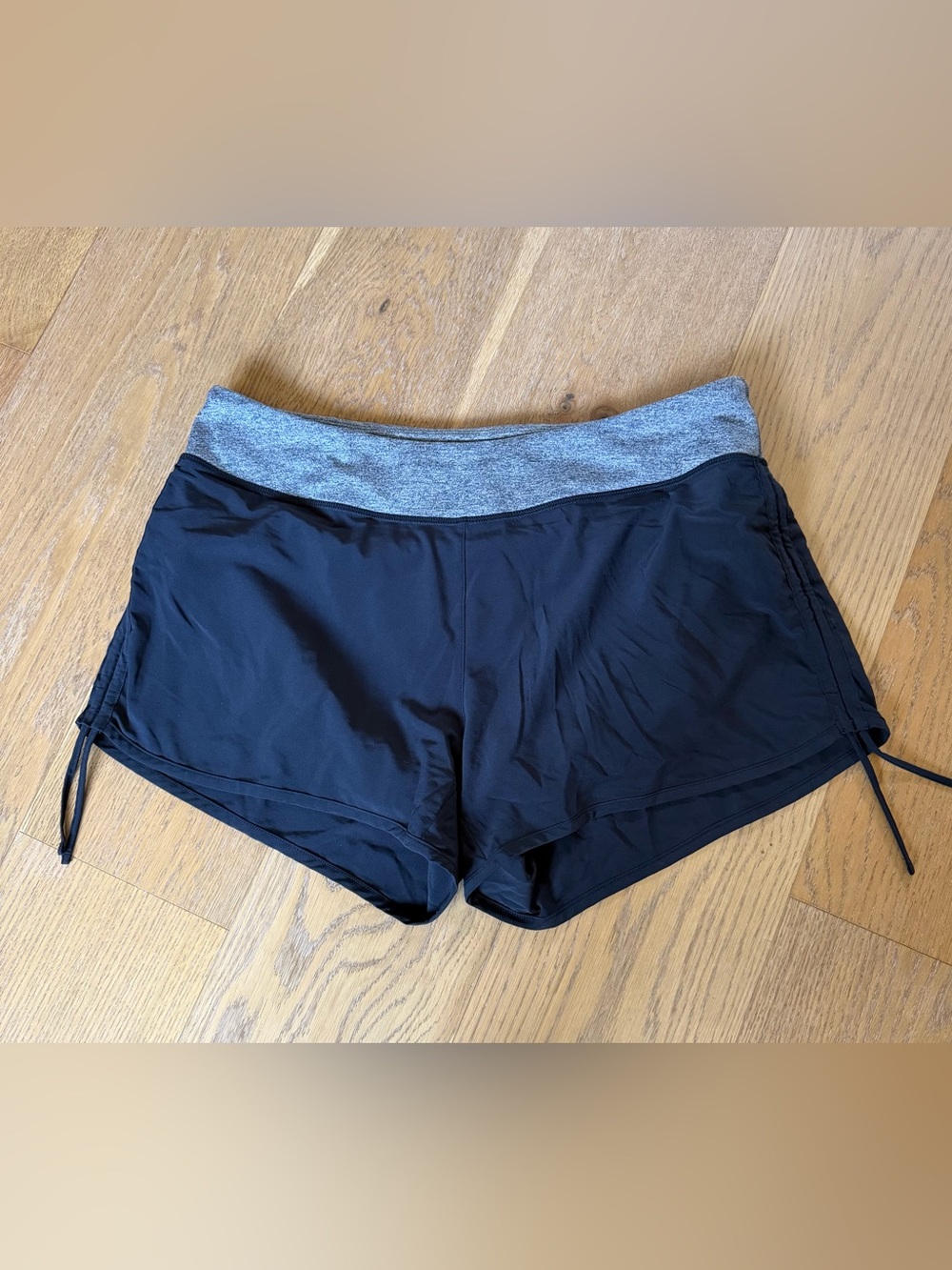 Lucy Flex Black Athletic Shorts with rushing on the sides.